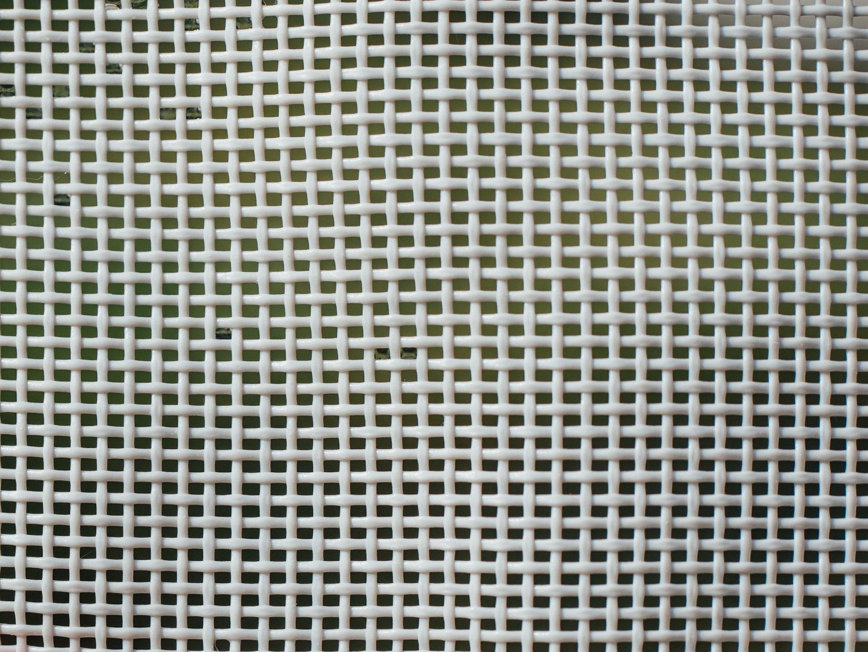 Hands holding a blue strap attached to a mesh material.